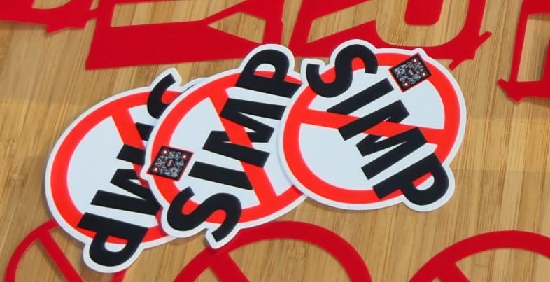 A pile of NO SIMP stickers with QR codes