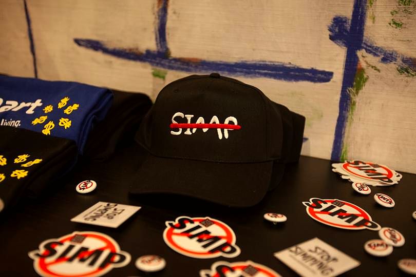 No Simp merch table with caps and stickers